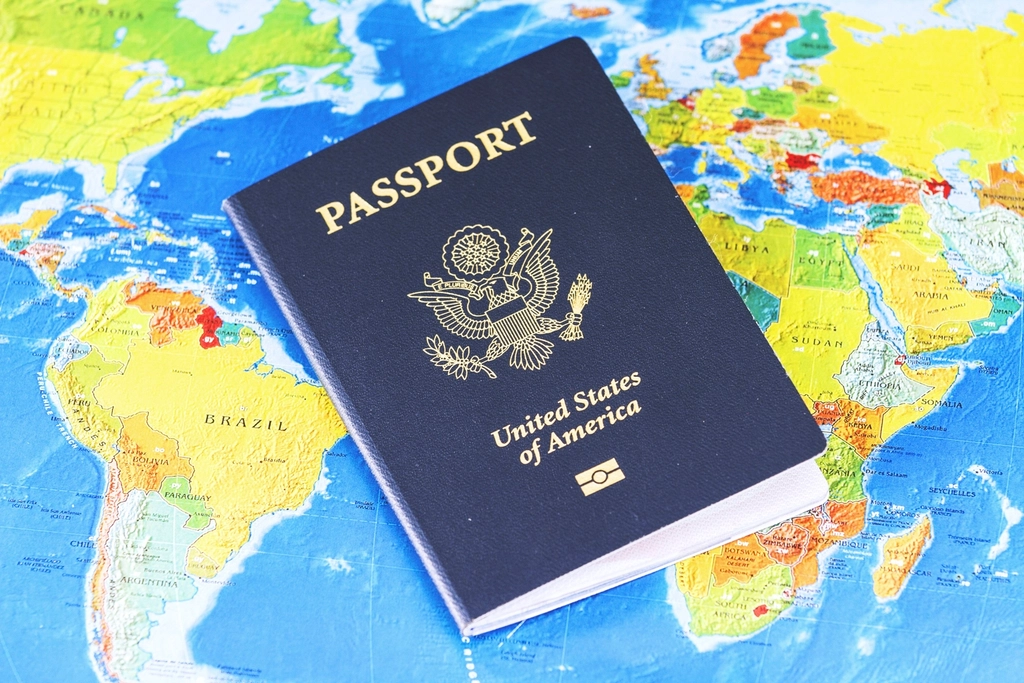 A passport laying on a global map